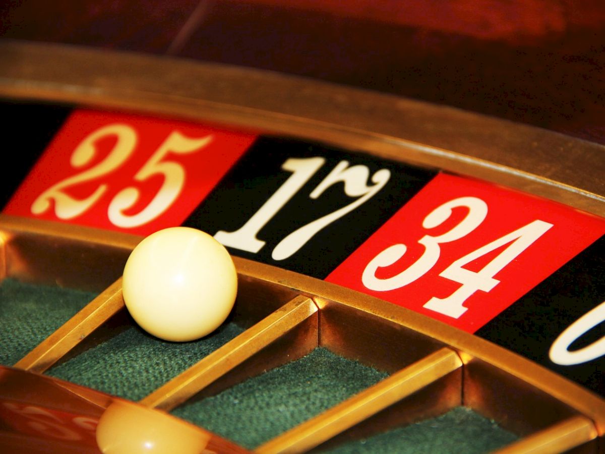 A close-up of a roulette wheel showing the ball landed on 17, with adjacent numbers 25 and 34 visible.