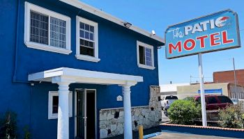 This image shows a blue building with a sign reading 